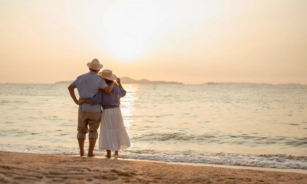 Older Couple on Beach with sunset